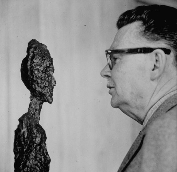 Art collector G. David Thompson examining a sculpture by Alberto Giacometti. Image:  Yale Joel/The LIFE Picture Collection via Getty Images. © The Estate of Alberto Giacometti (Fondation Giacometti, Paris and ADAGP, Paris), licensed in the UK by ACS and DACS, London 2021.