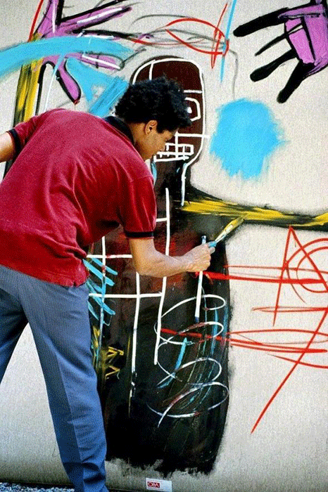 Jean-Michel Basquiat in 1983, working on a painting in St Moritz, Switzerland. Photograph by Lee Jaffe/Getty Images.